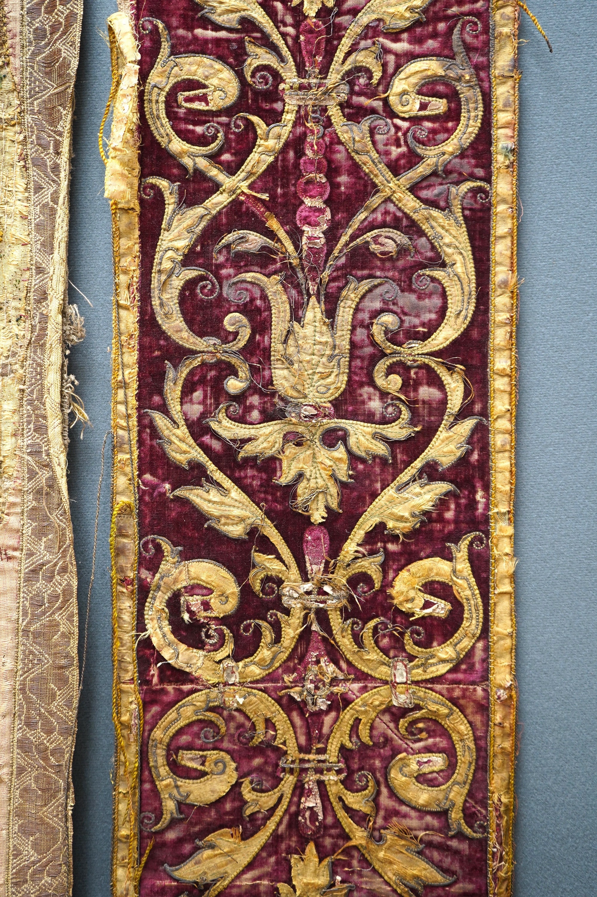 A fine Italian Renaissance style velvet, embroidered and appliqué wall hanging, originally part of a pilaster hanging, made with crimson silk velvet, gold appliqué and colourful polychrome silk embroideries of parrots an